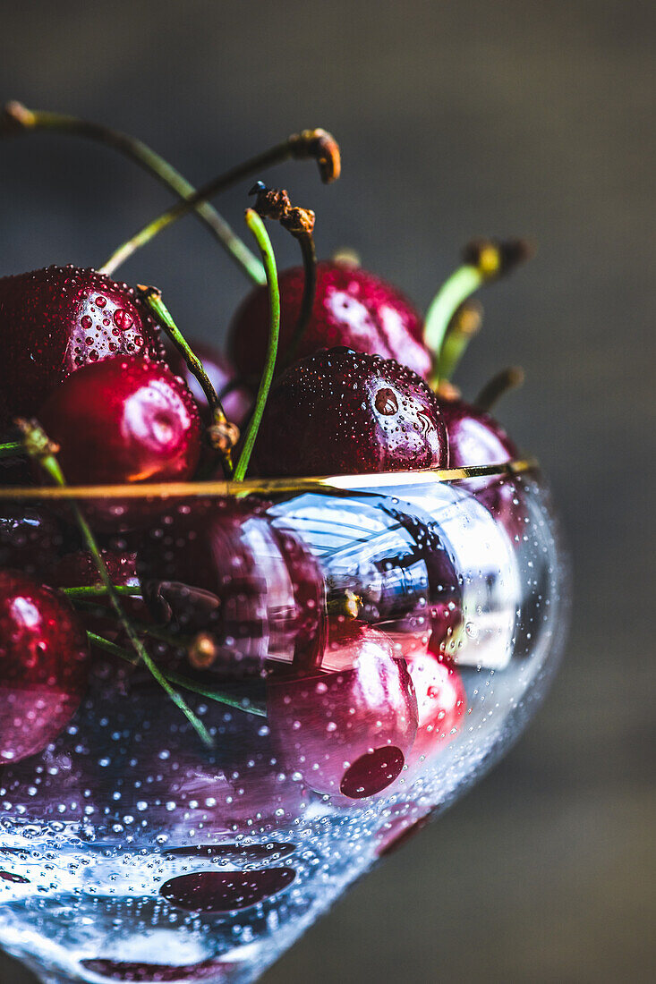 Organic sweet cherries in a champagne glass (Close Up)