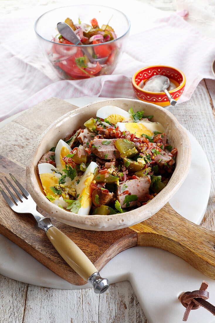 Salad with duck breast, egg, cucumber, and red rice