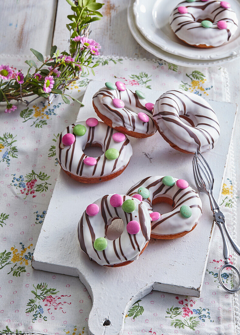 Easter donuts with sugar icing and coloured chocolate lentils
