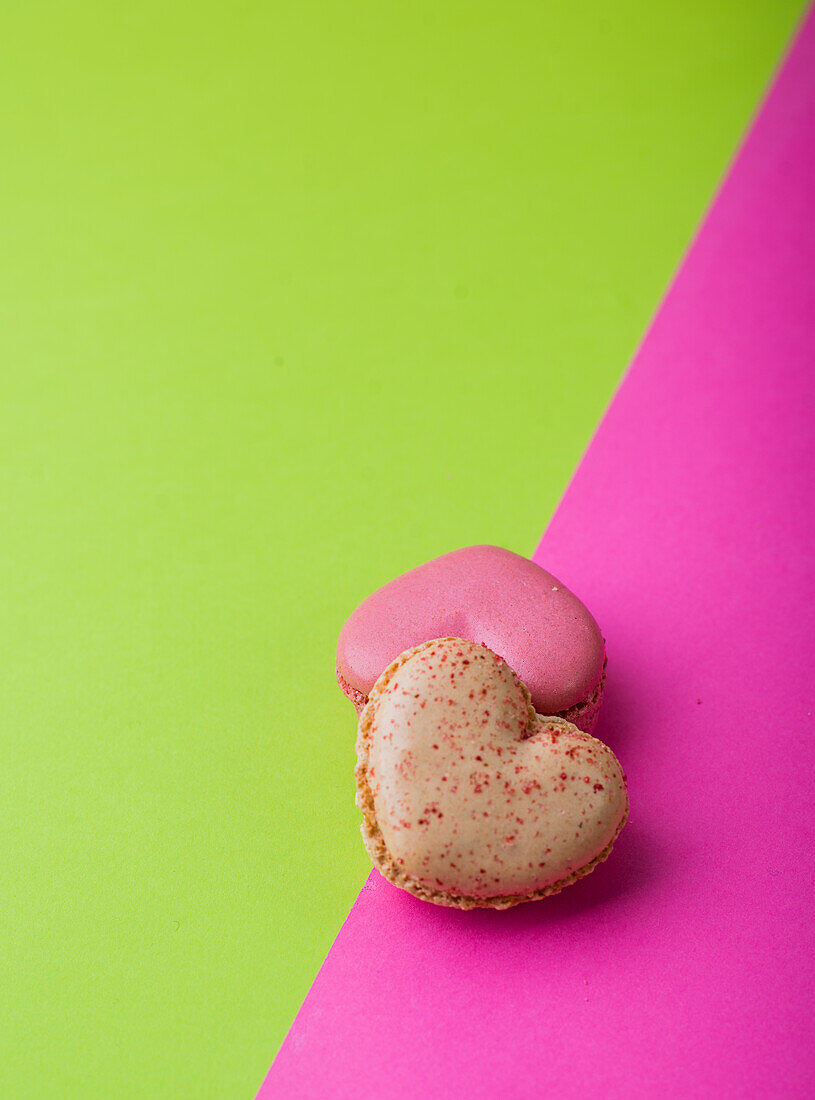 Herzförmige Macarons auf zweifarbigem Untergrund
