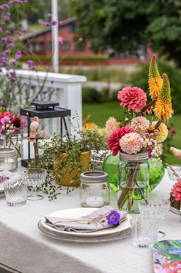 Set table with bouquet of dahlias on the terrace