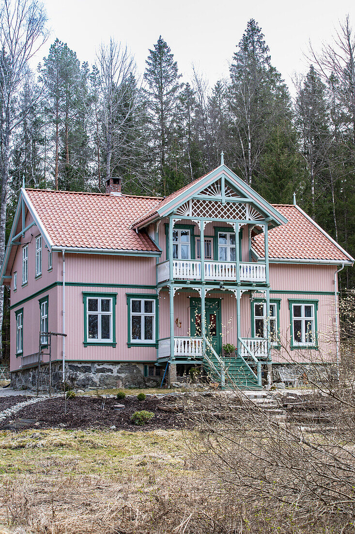 Rosa gestrichenes Holzhaus mit Balkon