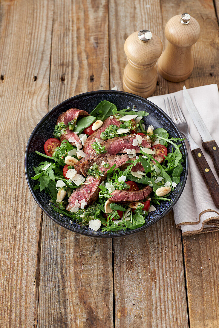 Tagliata with rocket and spinach salad and parmesan cheese