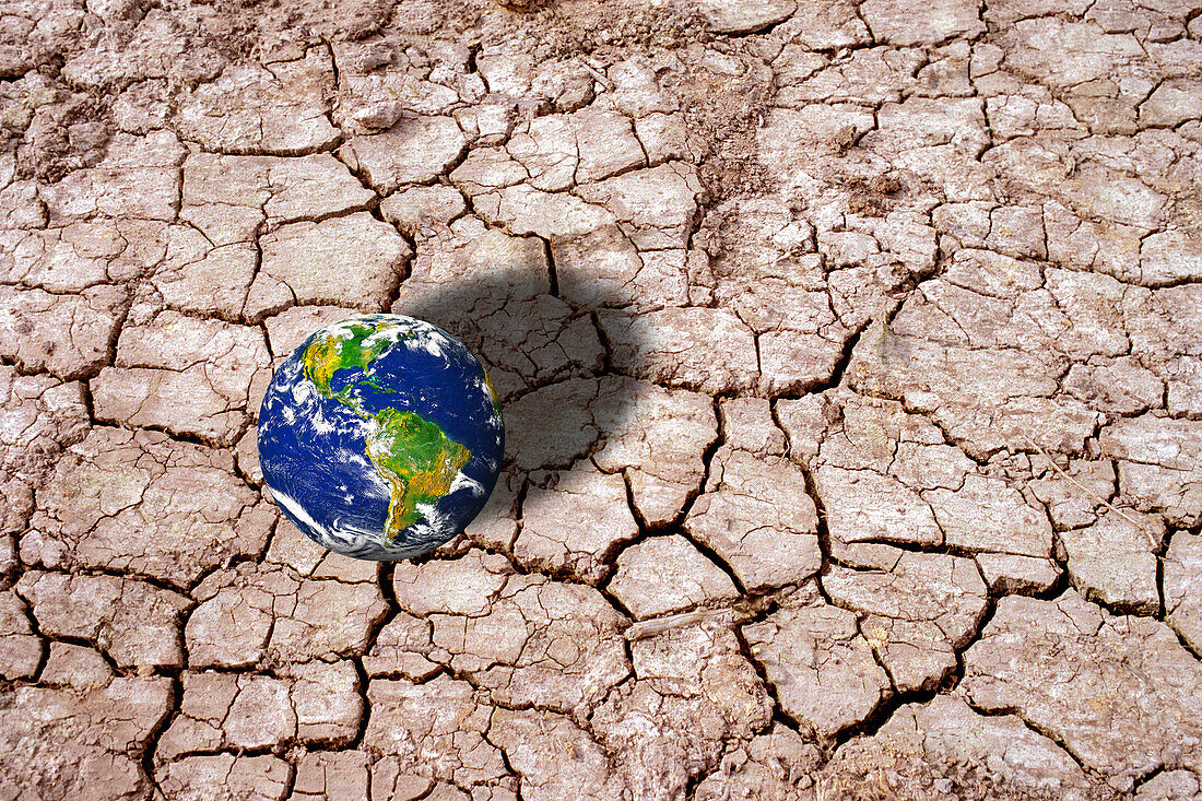 Planet Earth on cracked mud, conceptual illustration