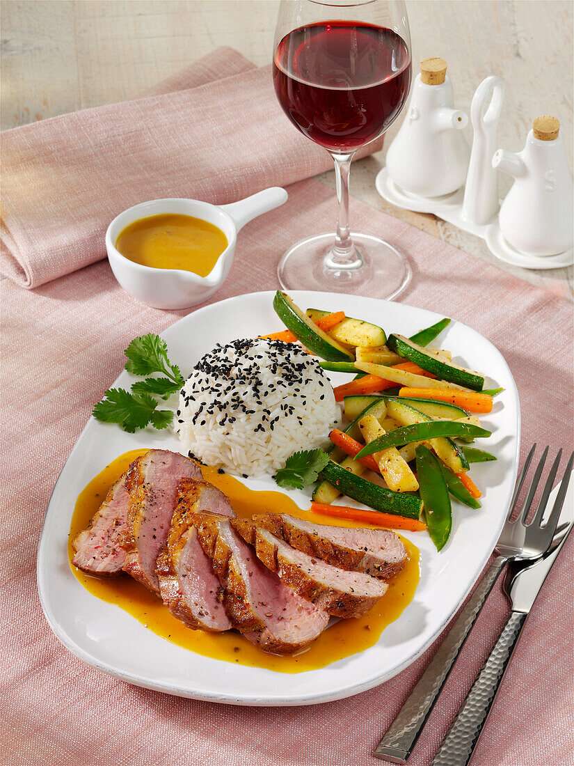 Duck breast with orange sauce and zucchini-carrot vegetables