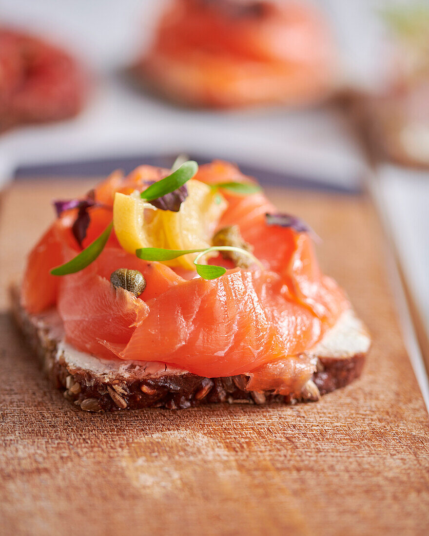 Open faced sandwich on sourdough rye bread with smoked salmon and capers