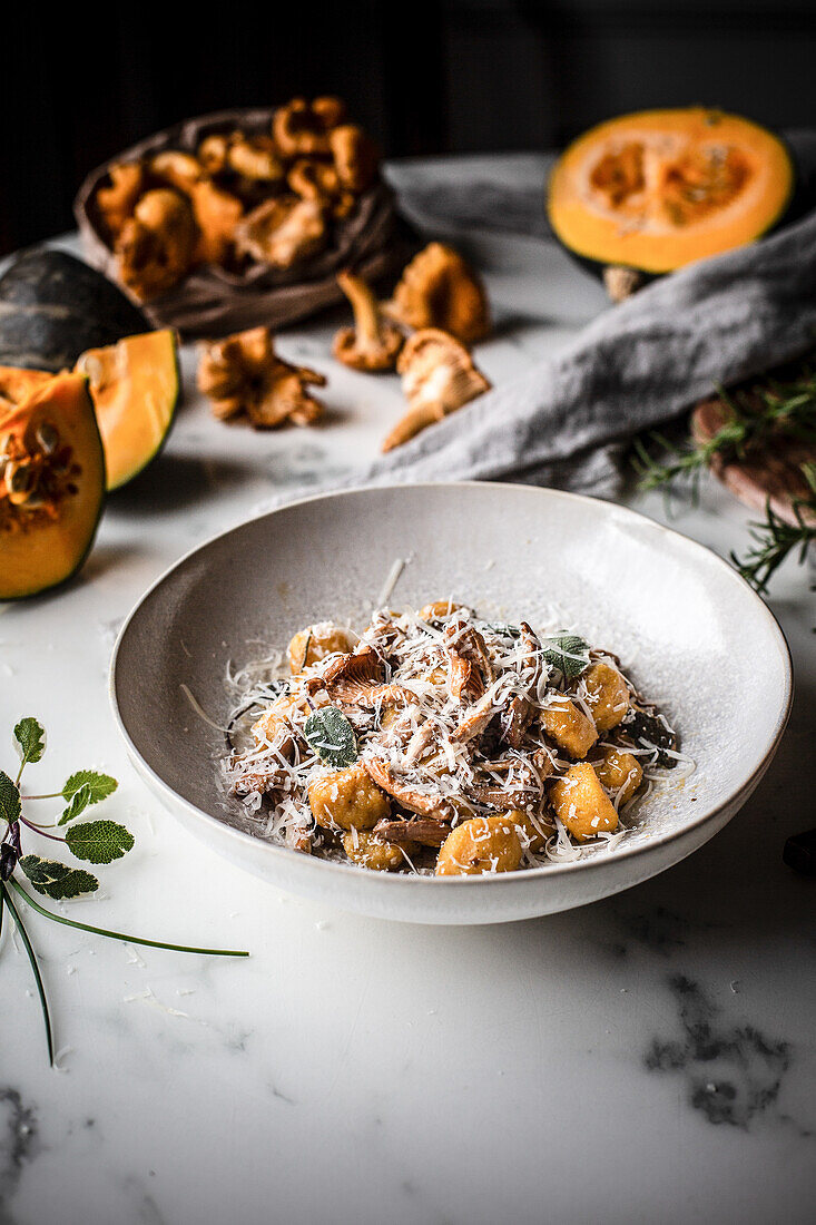 Pumpkin gnocchi with chanterelles, olive oil, and parmesan cheese