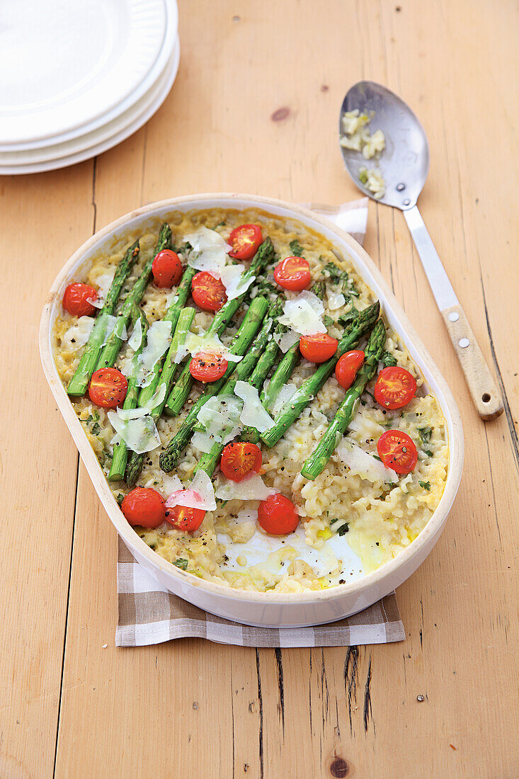 Baked asparagus risotto with cherry tomatoes and cheese