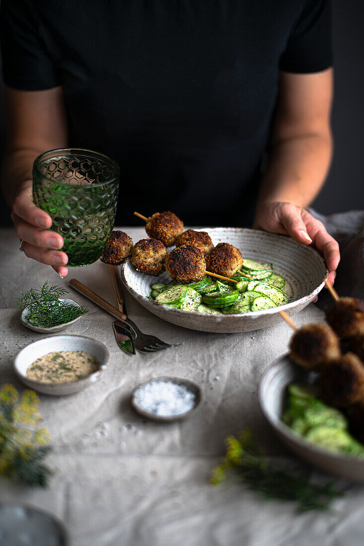 Meatballs on skewers with cucumber salad