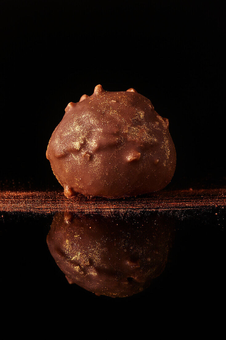 Chocolate truffles against a black background
