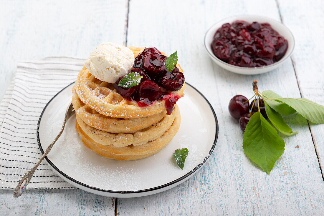 Waffles with cherry compote and vanilla ice cream