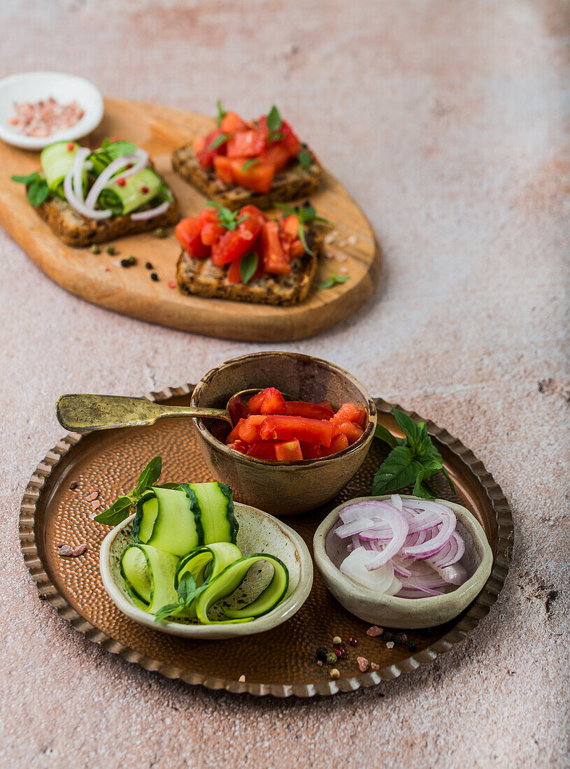 Gegrillte Brotscheiben mit frischen Tomaten, Gurken und roten Zwiebeln