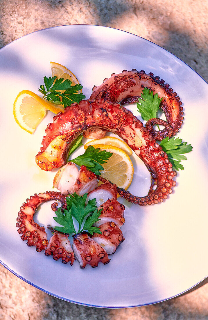 Grilled octopus with lemon slice