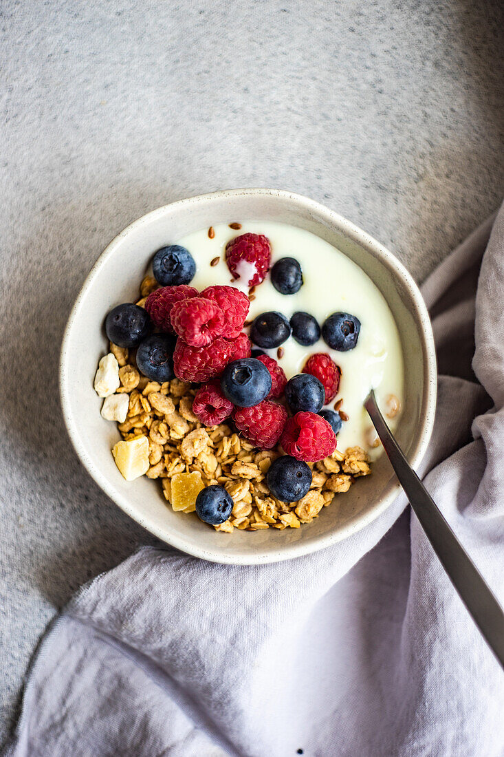 Healthy breakfast with berries and yogurt in a bowl