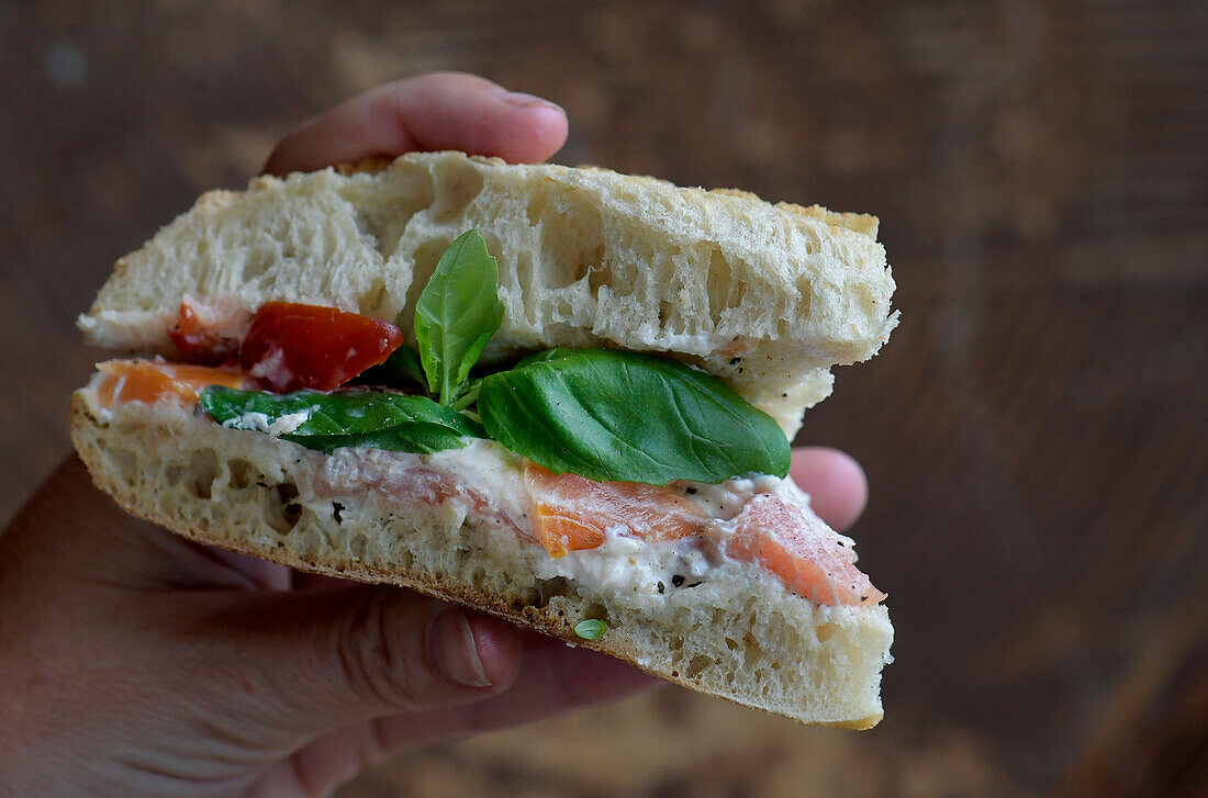 Sandwich with smoked salmon, tomato, and basil
