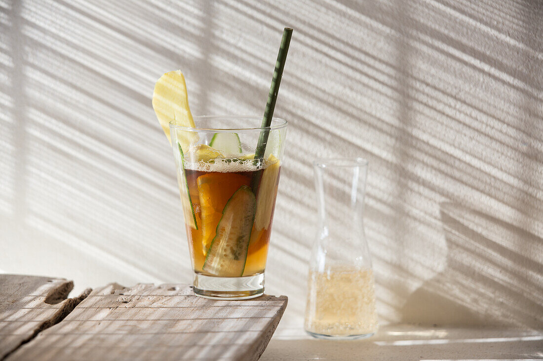 Pimm's Rangoon (drink with Pimms, ginger ale, and cucumber strips)