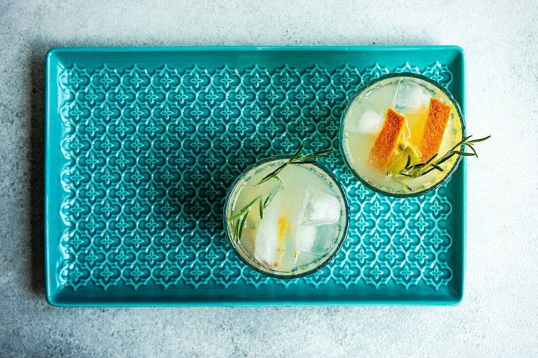 Glasses with summer cocktail - tonic and vodka decorated rosemary herb