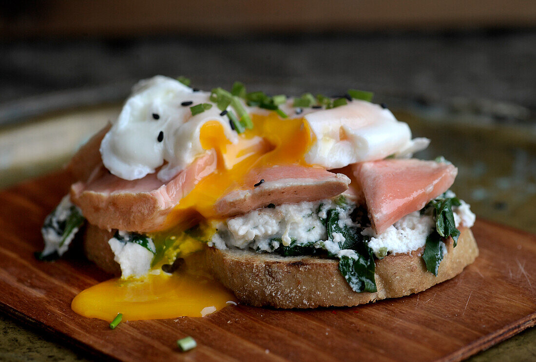 Toast with Earl Grey salmon, a poached egg and spinach ricotta