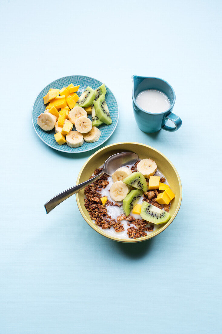 Coconut granola with bananas, kiwi, and mango