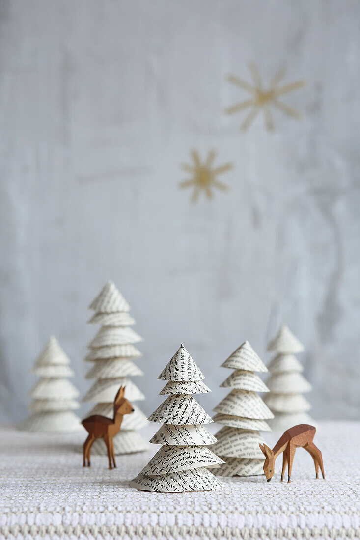 DIY Christmas trees made of book pages and wooden deer figurines