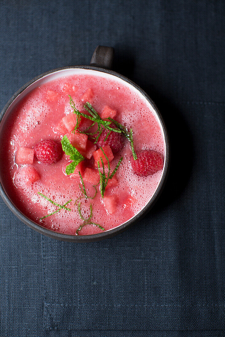 Vegan watermelon soup with raspberries and mint