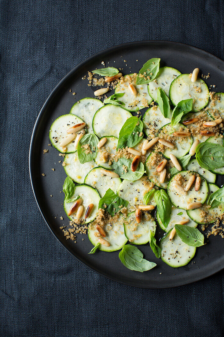 Vegan zucchini carpaccio with toasted pine nuts
