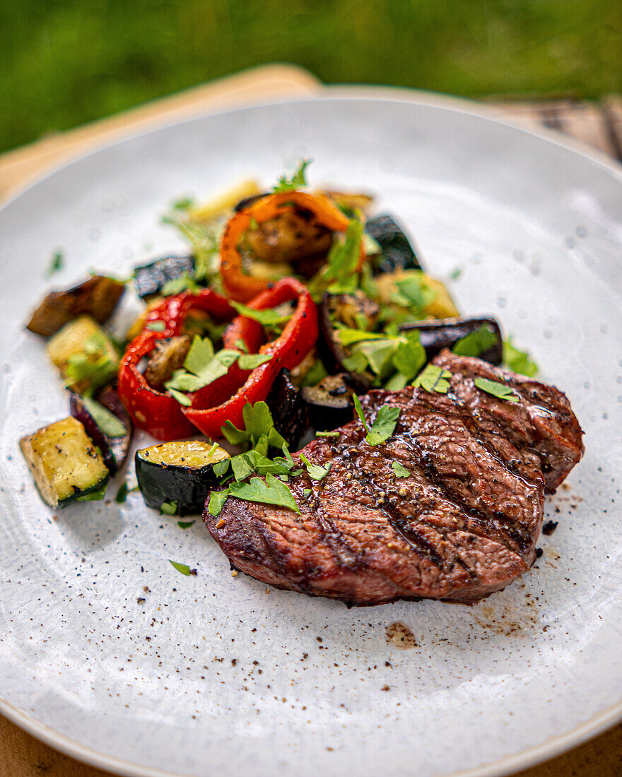 Grilled steak with grilled vegetables on a plate