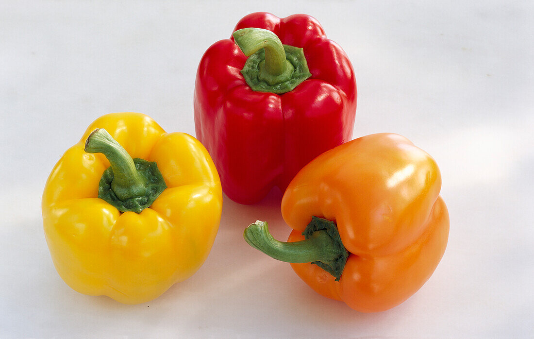 Three peppers, yellow, red, and orange