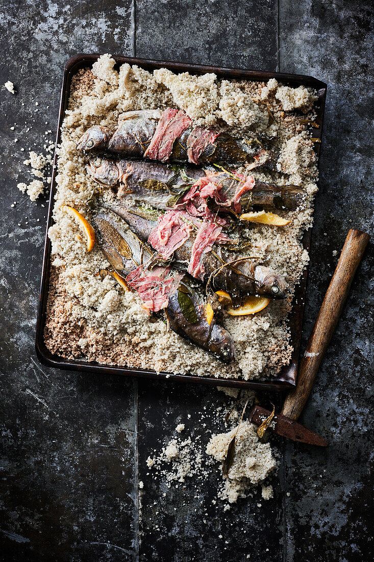 Grilled trout with bacon in a salt crust