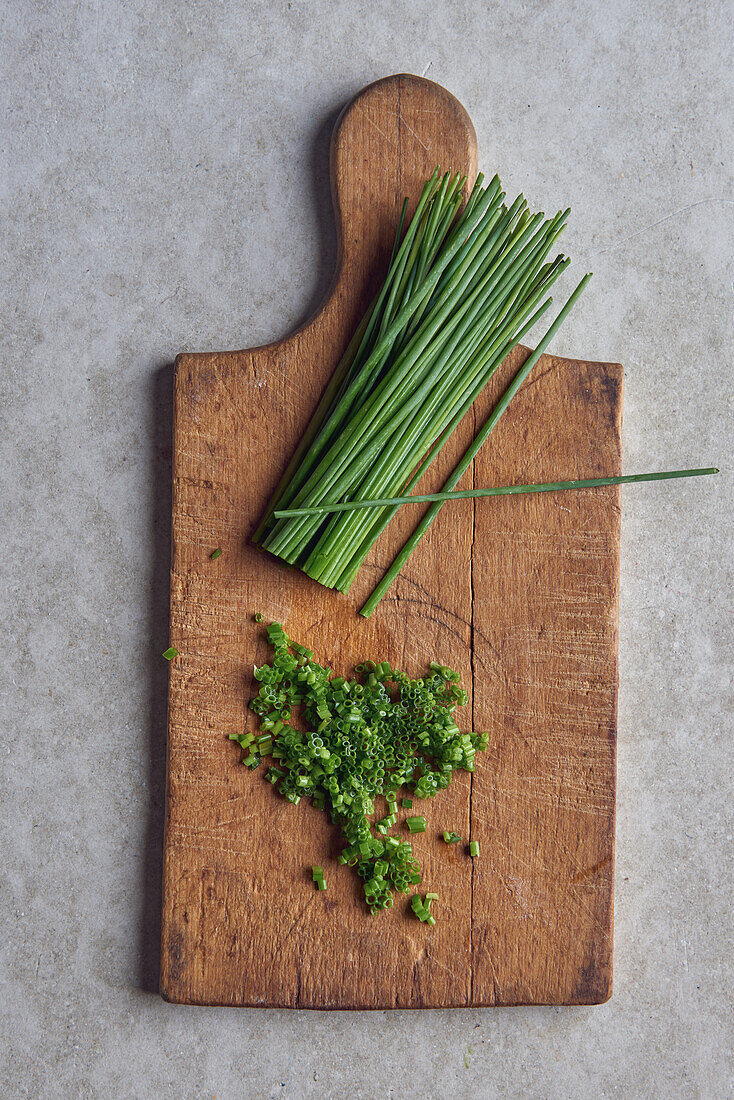 Chopped chives on a wooden board