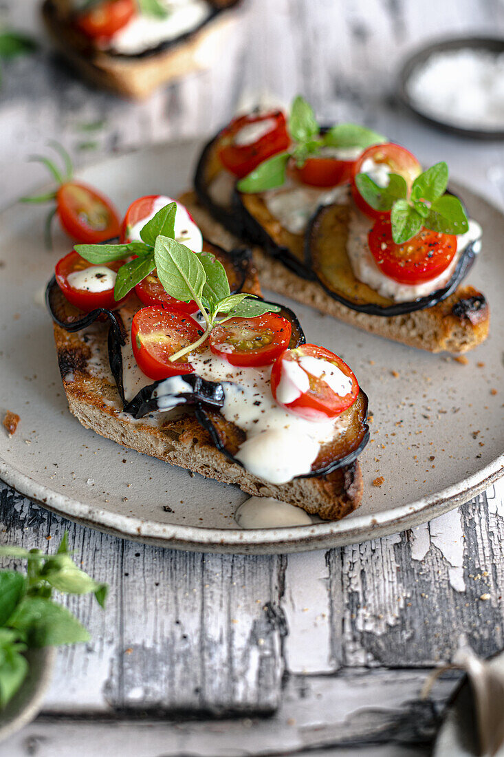 Bruschetta with eggplant, tomatoes, and yogurt dressing