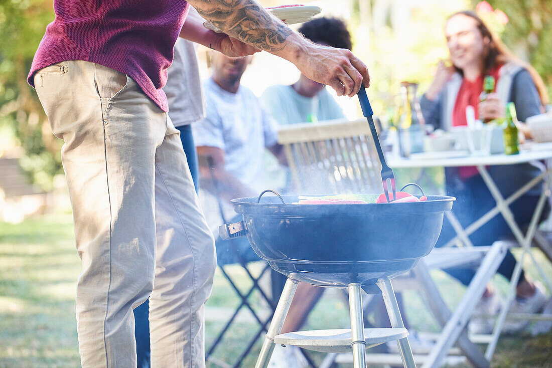 Young people having a barbecue in the garden