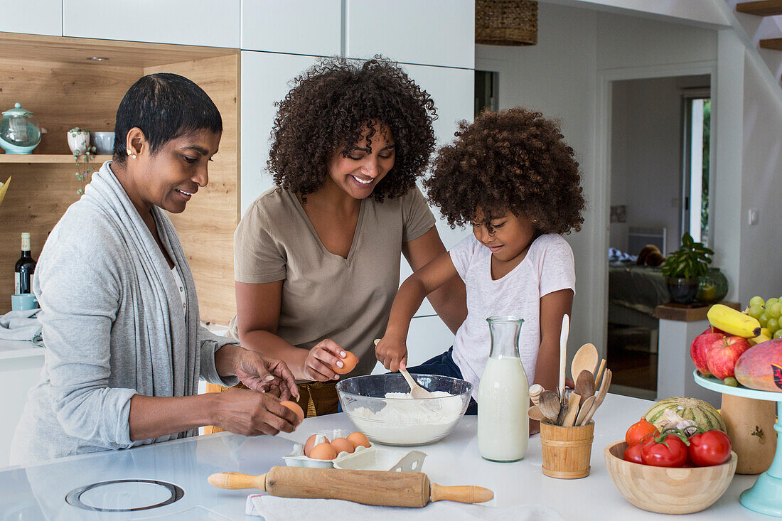 Multi-generation family preparing cookies