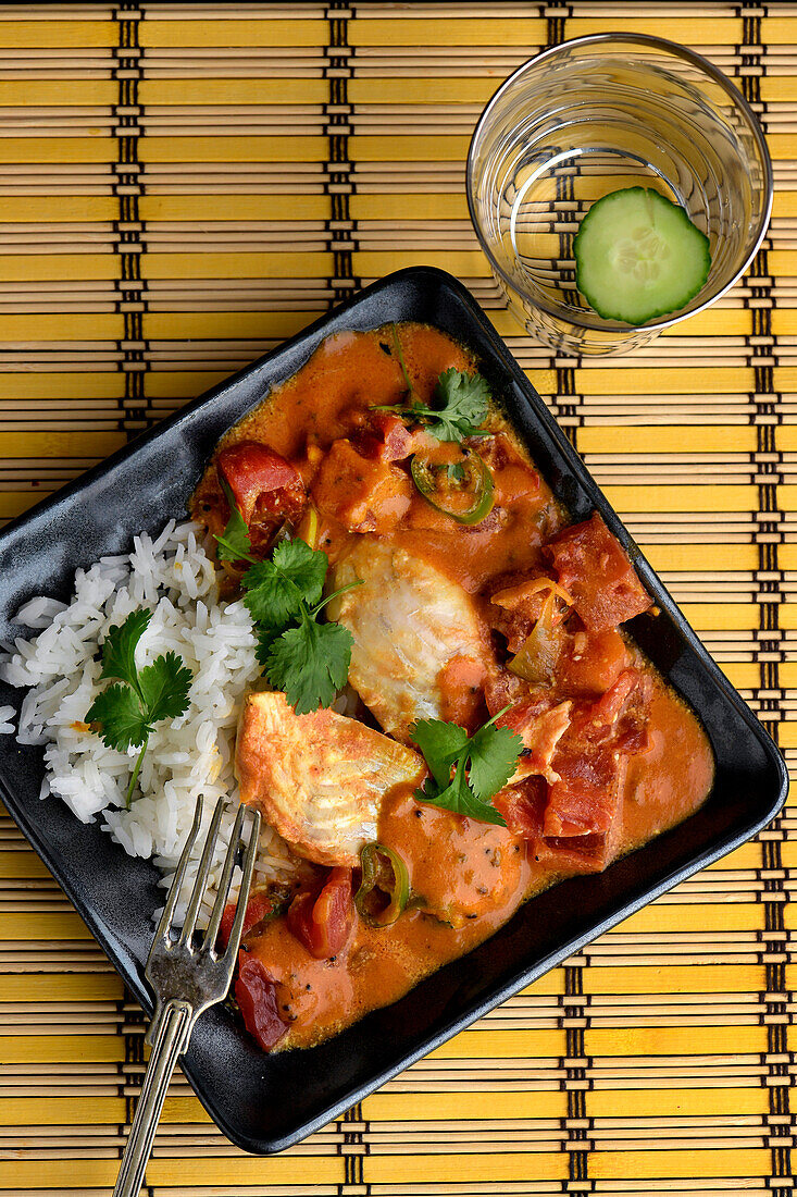 Indian fish in spicy tomato sauce with rice