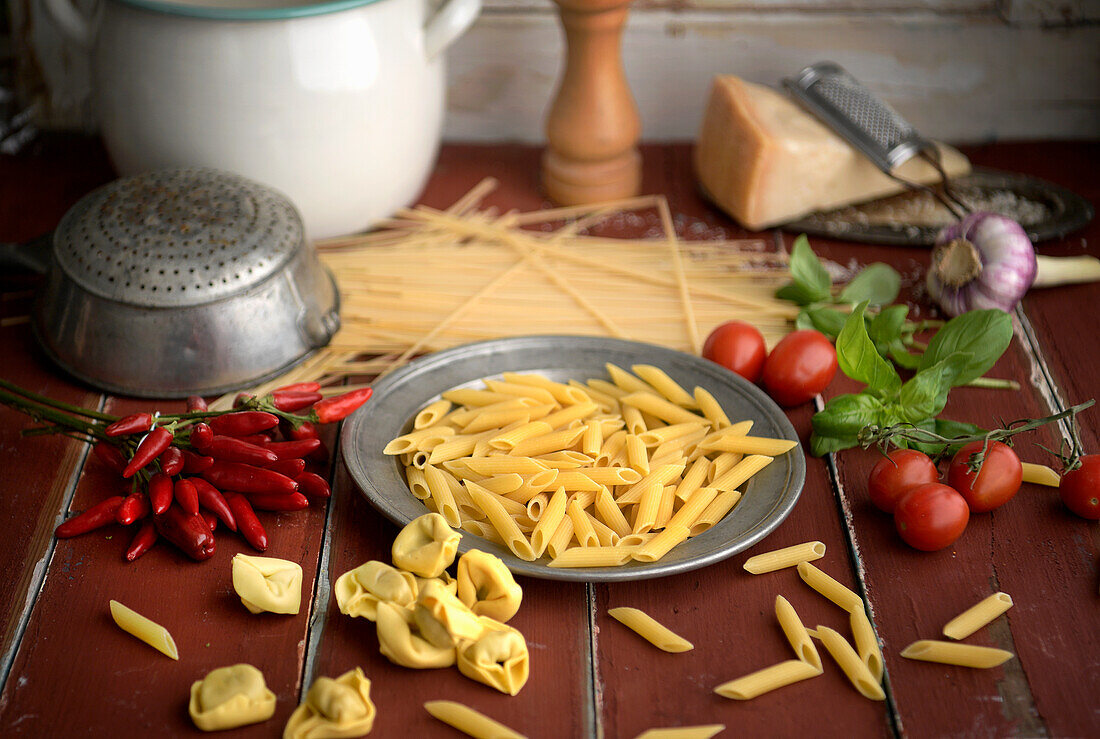 Still life with noodles, chillies, tomatoes and basil