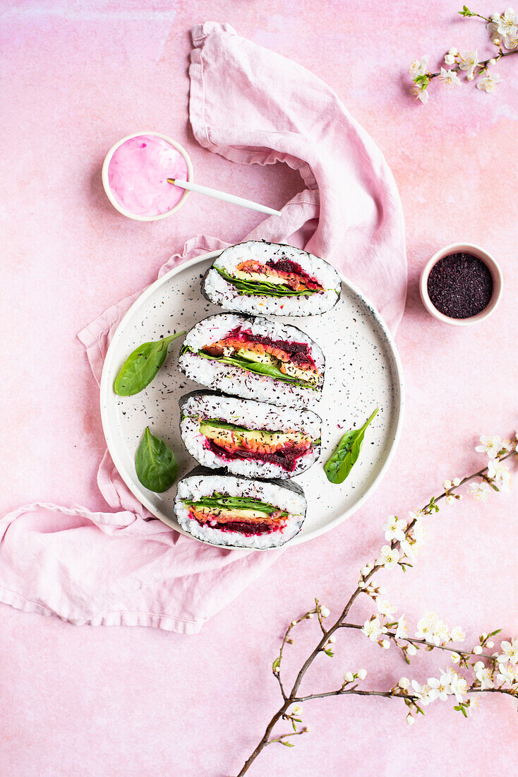 Rainbow onigirazu sandwiches with spinach, roasted beet, avocado, smoked salmon, sprinkled with furikake