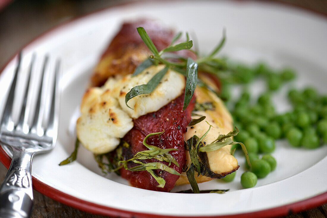 Chicken breast with roasted peppers, goat cheese, Serrano ham, and tarragon