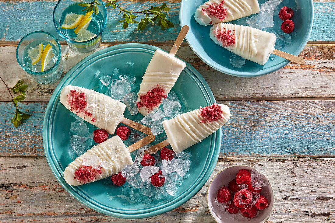 Raspberry popsicles coated in white chocolate
