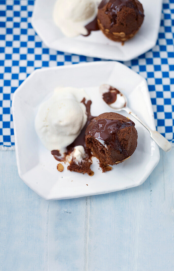 Chocolate almond puds with warm chocolate sauce and vanilla ice cream