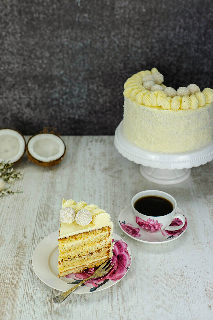 Coconut cake, cut with coffee