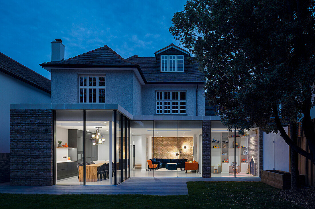 View from the garden into the illuminated living room