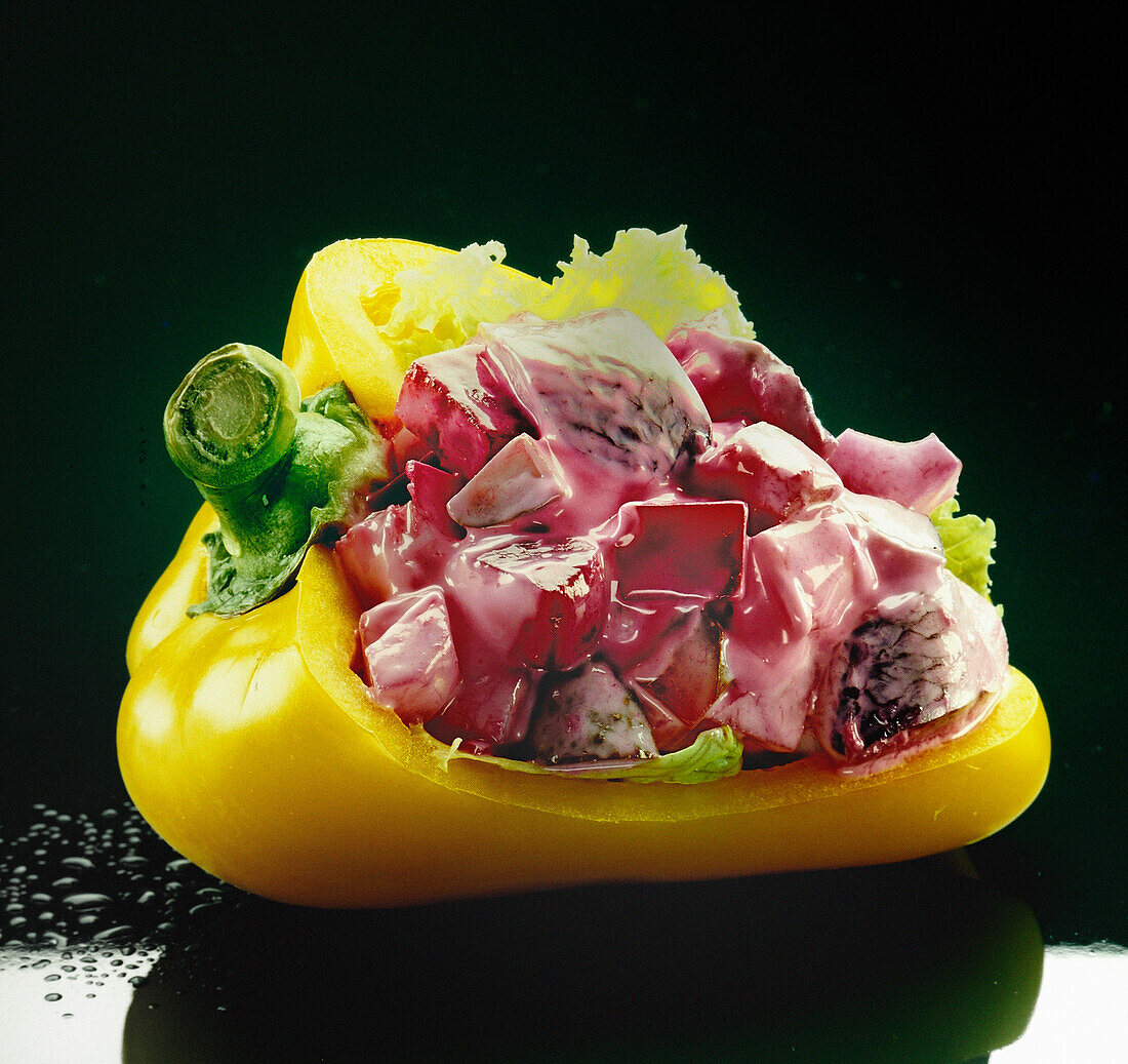 Herring salad served in yellow peppers
