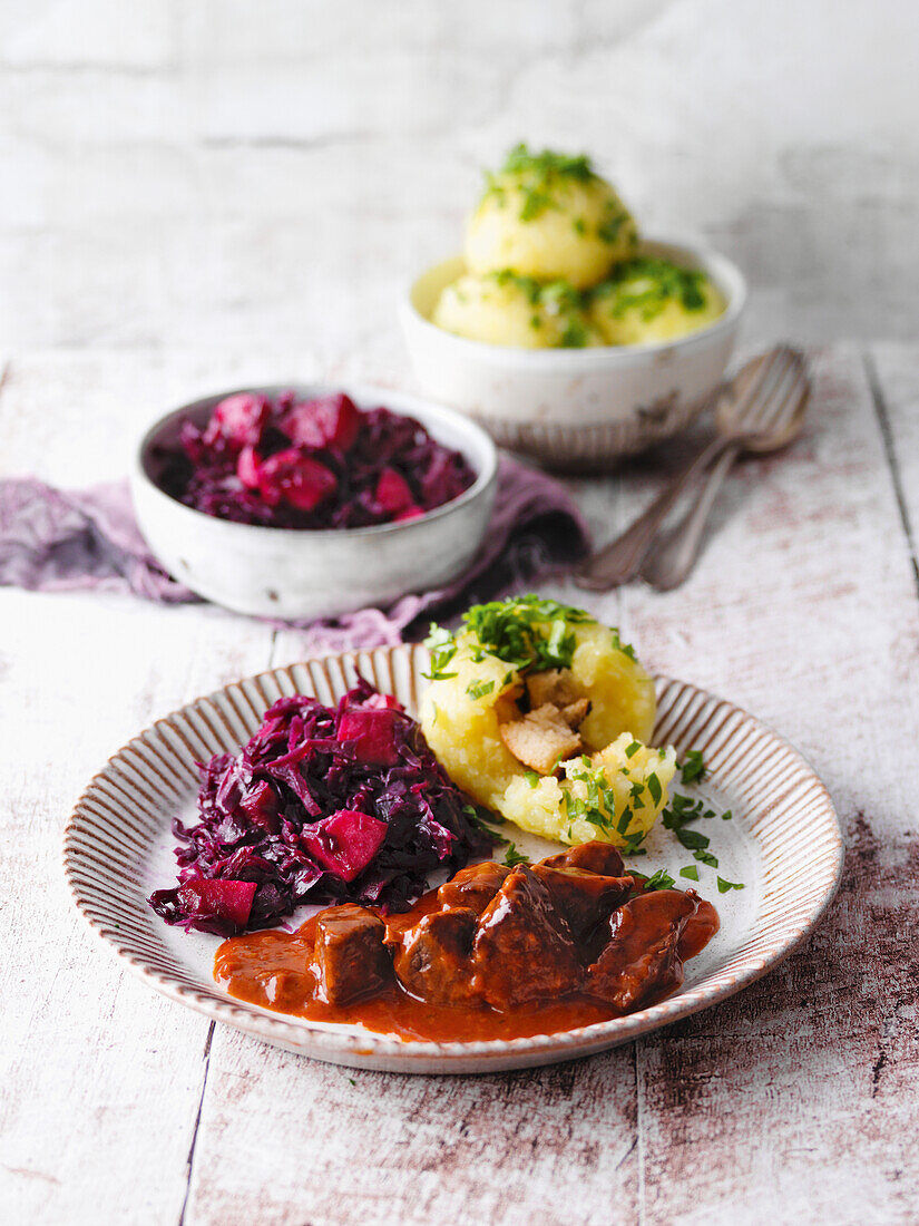 Pasture-raised beef goulash with red cabbage and German potato dumplings