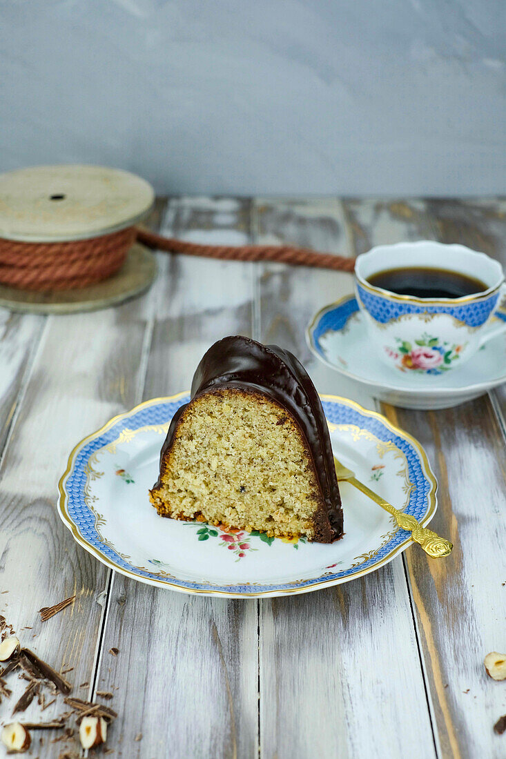 A piece of nut gugelhupf with chocolate icing to go with coffee