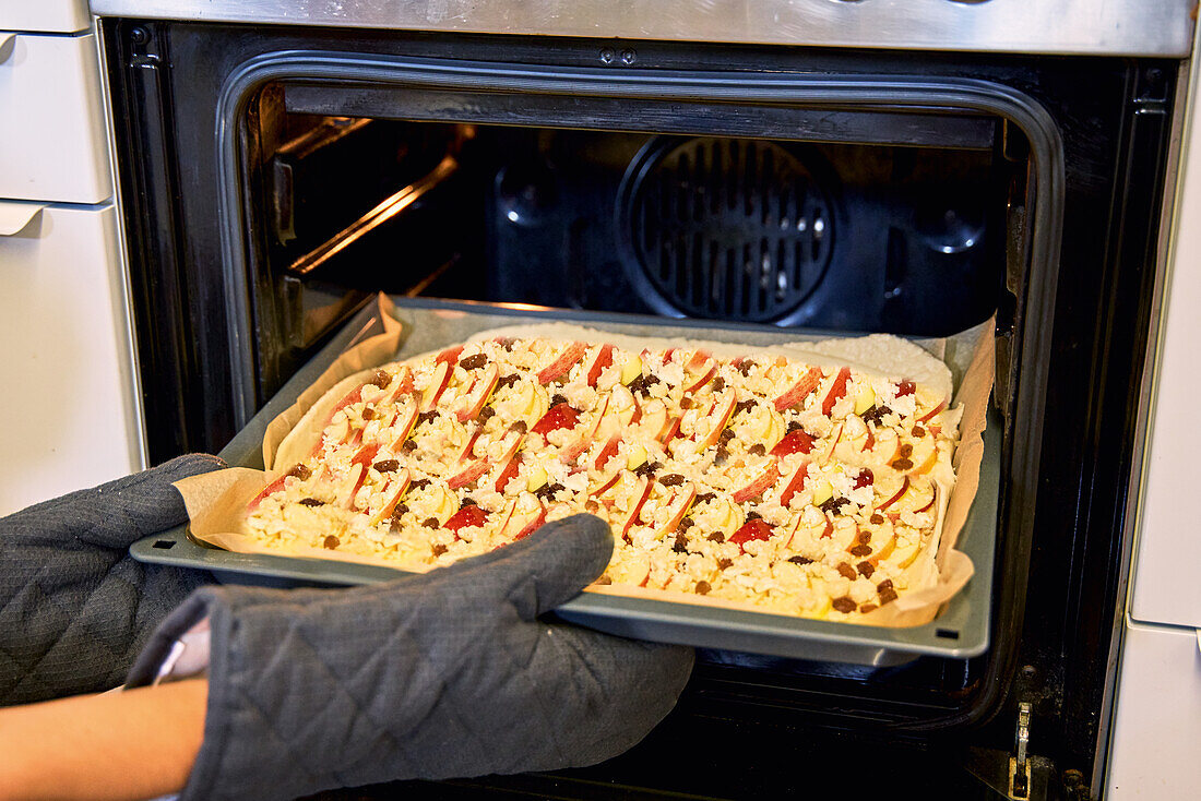 Put a baking tray into the oven