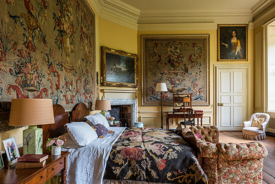 Tapestries and floral ceiling in the bedroom of a 17th century English country house