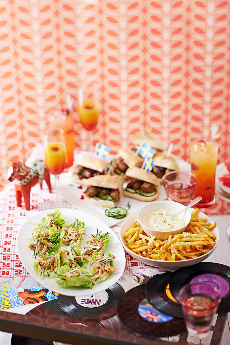 Cocktails, swedish meatball sandwiches, fries with cheese, and lettuce wraps