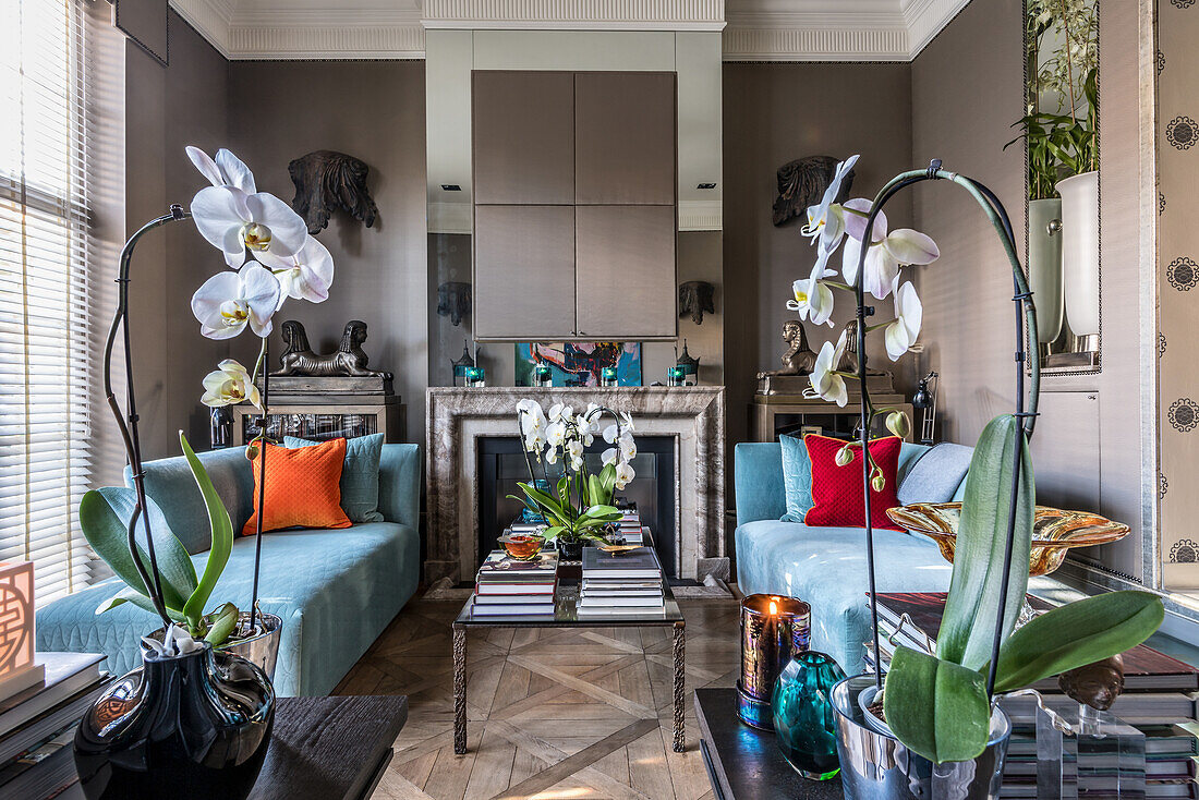 Light blue daybeds, marble fireplace, concealed television above