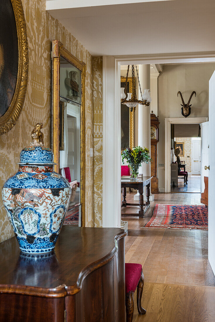 Chinese urn on antique sideboard in an English country house