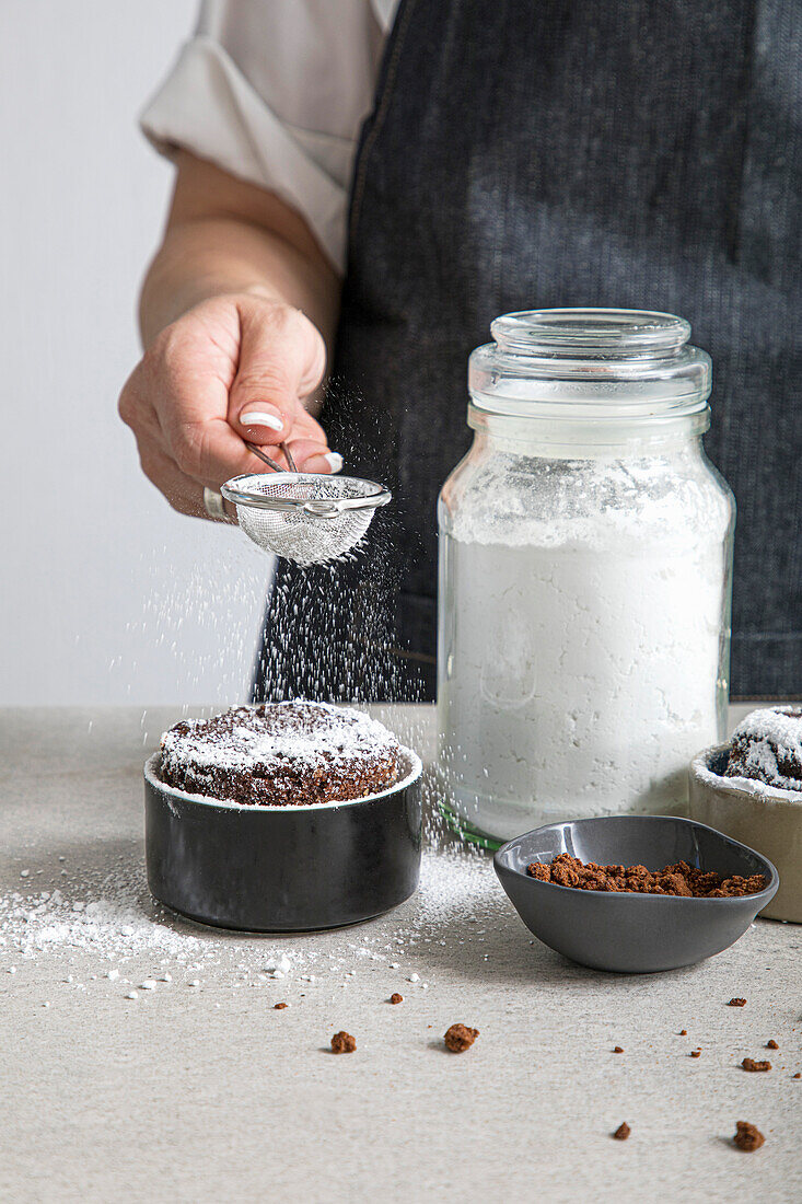 Dusting icing sugar onto a chocolate Souffle